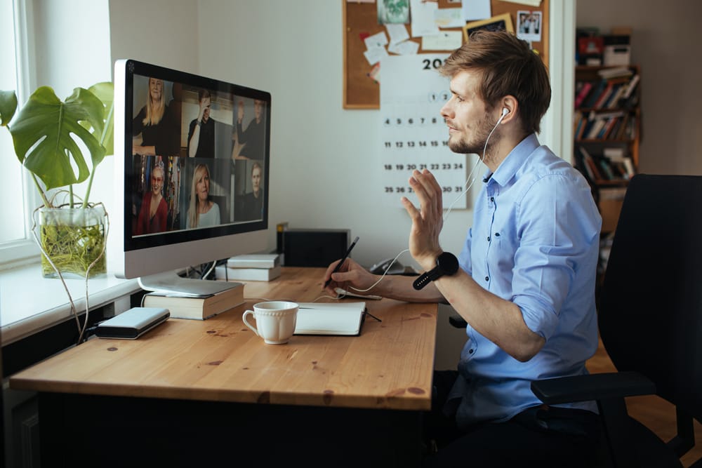 Person attending a video conference on a desktop